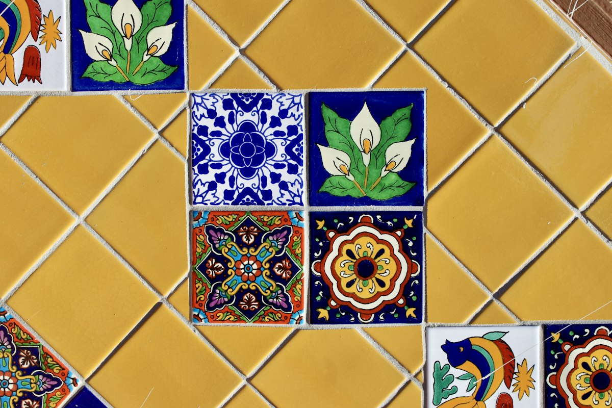 Hand-painted Talavera tiles set into a yellow tile wall