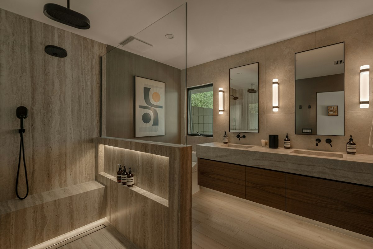 Walk-in shower and bathroom finished in travertine-look stone