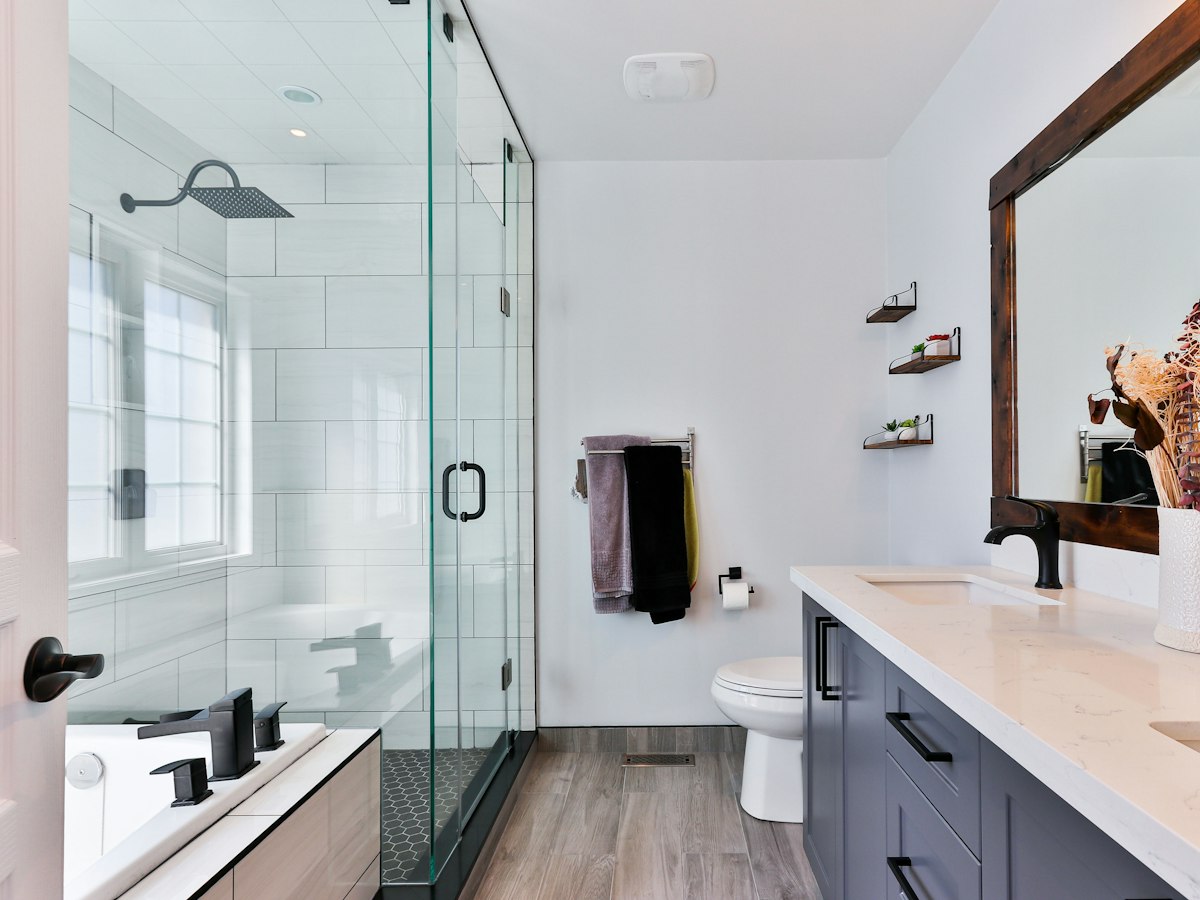 Bathroom with a glass tile shower and a vanity