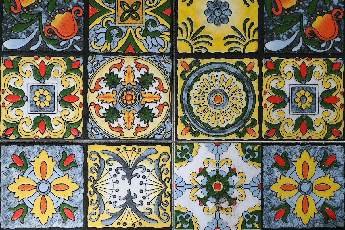 A grid of hand-painted Talavera-style tiles in yellow, blue and red