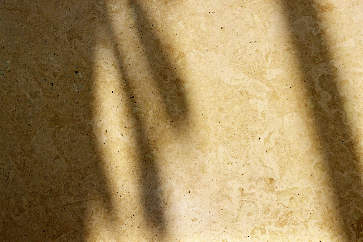 Cream travertine-style stone floor in window light